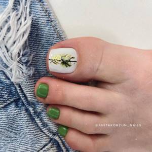 White and green shellac pedicure with stickers