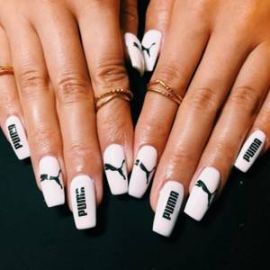 White manicure with inscriptions on square nails.