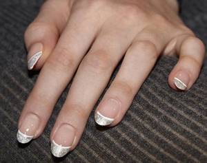 White manicure with a predominance of silver