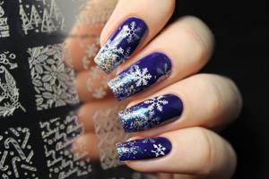 Glitter in winter manicure with snowflakes.