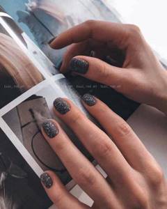 Black manicure with glitter