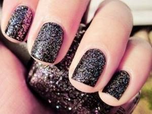 Black manicure with liquid glitter