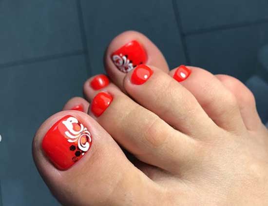 Flowers and monograms on red background of toenails