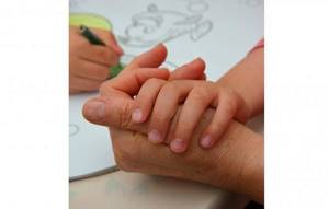 Child&#39;s hand on an adult