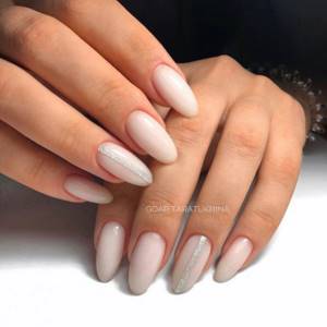 Long almond-shaped nails and milky manicure