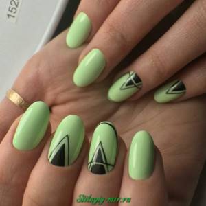 Photo of a manicure with a pattern in shades of green