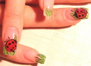French manicure: ladybugs on the tips of the nails.