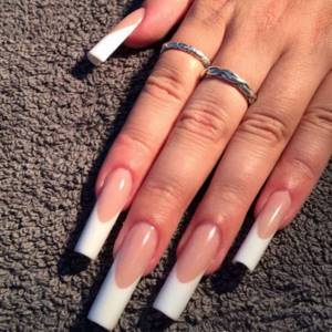 Classic French manicure on long nails with a sharp square shape.
