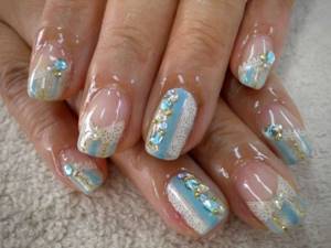 Beautiful manicure with lace and stones in white and blue tones