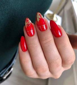 Red manicure with gold foil