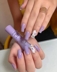 Lavender manicure with purple flowers on square nails.