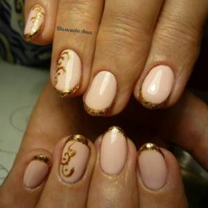 Beige manicure with gold jacket