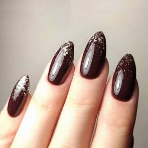 Brown manicure with glitter on almond