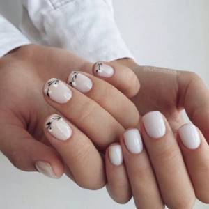 Milky manicure with a twig pattern on the nails of one hand