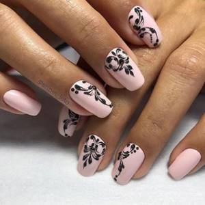 nude pink manicure with black design