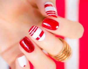 Manicure with stripes in red and white tones