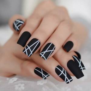 Matte black manicure with white graphic design.