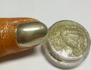 Metallic manicure on gel polish with chrome pigment