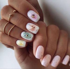 A fashionable, interesting manicure in pleasant colors on square-shaped nails.