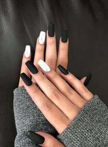 Marble manicure and matte black finish on long square nails.