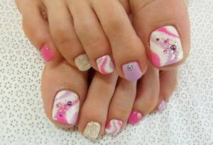 The photo shows a beautiful pedicure with rhinestones
