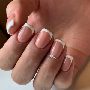 Delicate wedding manicure for the bride on short nails.