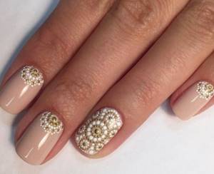 Nude manicure with golden-white dotted pattern