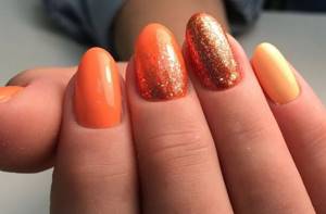 Orange manicure with glitter