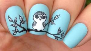 Panoramic manicure with an owl sitting on a branch