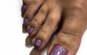 Pedicure with lilac shimmer polish