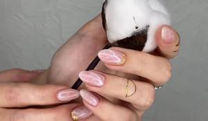 An example of pink marble manicure on oval nails