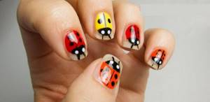 Multi-colored ladybugs on short nails - a manicure idea for a girl.