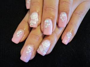 Pink manicure with beautiful white modeling and rhinestones