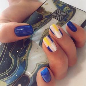 Blue manicure with a bright pattern on rectangular nails.