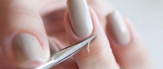 Removing cuticle with scissors.
