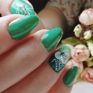 Green manicure with flowers