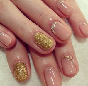 gold manicure with sparkles or rhinestones