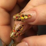 Gold manicure with beads